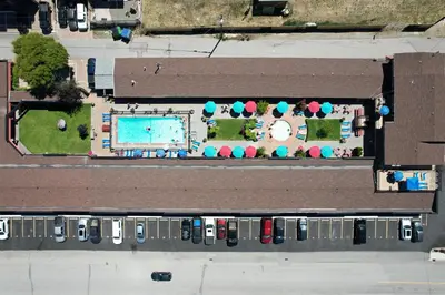 an overhead view of a pool and parking lot with cars at Sahara Courtyard Inn & Suites Osoyoos in Osoyoos