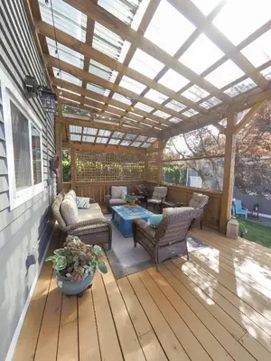 a pergola on a deck with a table and chairs at Money Pennies Bed and Breakfast in Campbell River