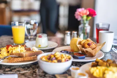 a table topped with plates of food and drinks at Coast Discovery Inn in Campbell River