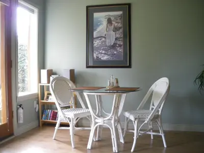 a dining room with a table and four chairs at Nestledown B&B in Halfmoon Bay