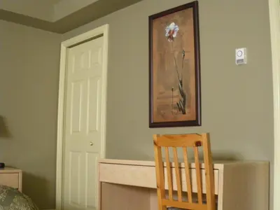 a room with a chair and a picture on the wall at Nestledown B&B in Halfmoon Bay