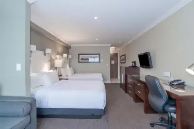 a hotel room with a large bed and a desk at Sandman Signature Langley Hotel in Langley