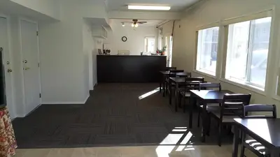 a dining room with tables and chairs and a counter at Cactus Tree Inn in Oliver