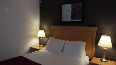 a hotel room with a bed with two lamps at Cactus Tree Inn in Oliver