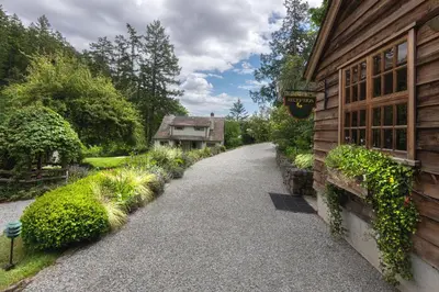 a walkway next to a house with a building at Hastings House Country House Hotel in Ganges