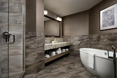 a bathroom with a tub and a sink at The Josie Hotel, Autograph Collection in Rossland
