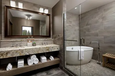 a bathroom with a tub and a sink and a mirror at The Josie Hotel, Autograph Collection in Rossland