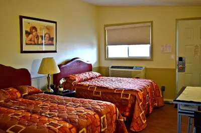 a hotel room with two beds and a window at Centre Suite Inns Motel in Bonnyville