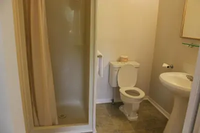 a bathroom with a toilet and a sink at Boundary Motel in Osoyoos