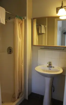 a bathroom with a sink and a mirror at Boundary Motel in Osoyoos