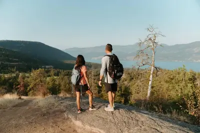 a man and a woman standing on top of a hill at Predator Ridge Resort in Vernon