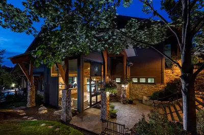 a home with the front door lit up at night at Predator Ridge Resort in Vernon