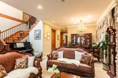 a living room with two couches and a staircase at An Yang House in Burnaby