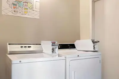 a laundry room with a washer and dryer at Thriftlodge Edmonton in Edmonton