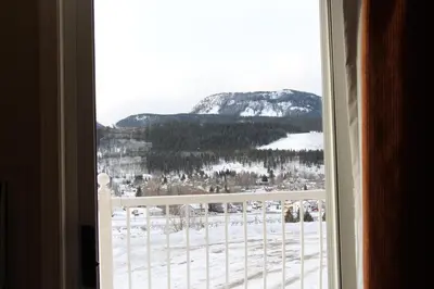 a view of a snowy mountain from a window at BCMInns - Coleman in Coleman