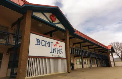 a building with a sign on the front of it at BCMInns - Peace River in Peace River