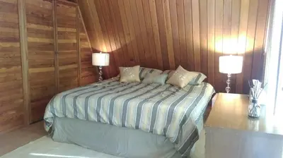 a bedroom with a bed with two lamps on it at Gabriola Central B&B in Gabriola