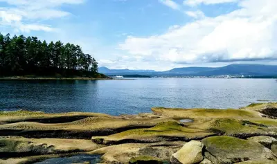 a large body of water with trees and rocks at Gabriola Central B&B in Gabriola
