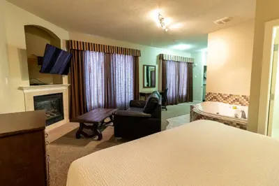 a hotel room with a bed and a fireplace at BCMInns - Lac La Biche in Lac La Biche