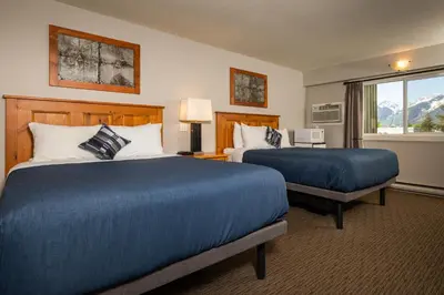 a hotel room with two beds and a window at Red Tree Lodge in Fernie