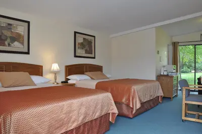 a hotel room with two beds and a window at Summerland Motel in Summerland