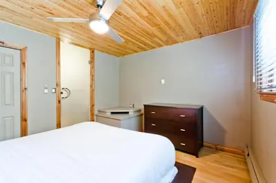 a bedroom with a white bed and a wooden ceiling at M Lofts in Calgary