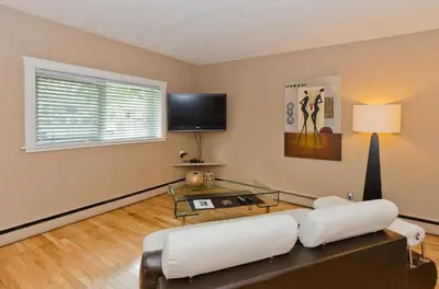 a living room with a couch and a glass table at M Lofts in Calgary