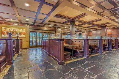 a tasting room with a bar with leather seats at Days Inn & Suites by Wyndham West Edmonton in Edmonton