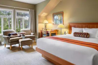 a hotel room with a bed and a chair at Long Beach Lodge Resort in Tofino