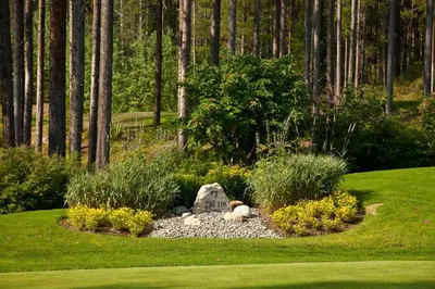 a garden with a stone grave in the grass at Trickle Creek Lodge in Kimberley