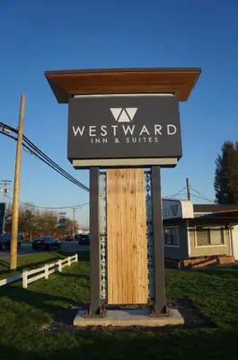 a sign for the westward firm and suites at Westward Inn & Suites in Langley