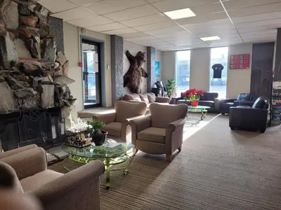 a lobby with couches and chairs and a fireplace at Valemount Vacation Inn in Valemount