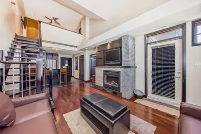 a living room with a fireplace and a tv at Copper Point Resort in Invermere