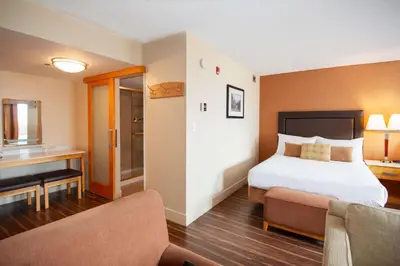 a hotel room with a bed and a couch at Coast Hillcrest Hotel in Revelstoke