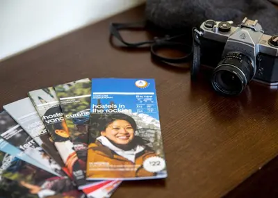a camera sitting on a table next to a magazine at HI Whistler - Hostel in Whistler