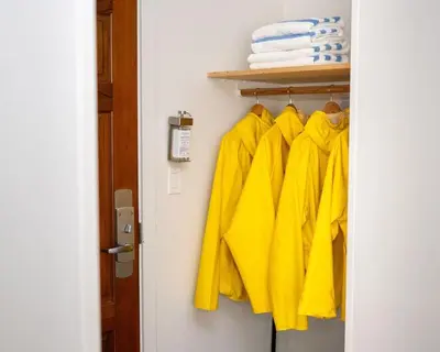 a bunch of yellow shirts are hanging on a closet at Pacific Sands Beach Resort in Tofino