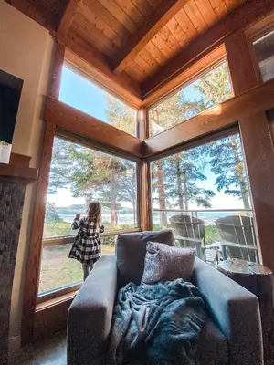 a little girl standing in a living room with a couch at Pacific Sands Beach Resort in Tofino