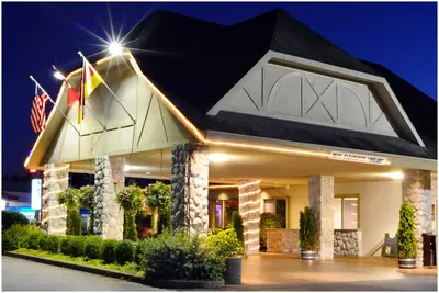 a hotel with flags in front of it at night at The Hospitality Inn in Port Alberni