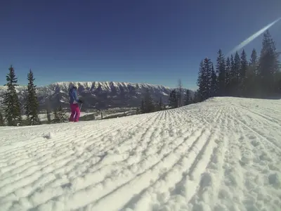 a person standing on top of a snow covered slope at Fernie Slopeside Lodge in Fernie