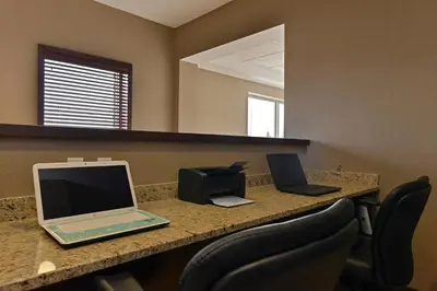 two laptop computers sitting on a counter in an office at Siding 16 Lodge in Wetaskiwin