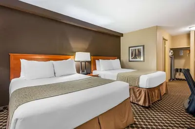 a hotel room with two beds in a room at Best Western Strathmore Inn in Strathmore