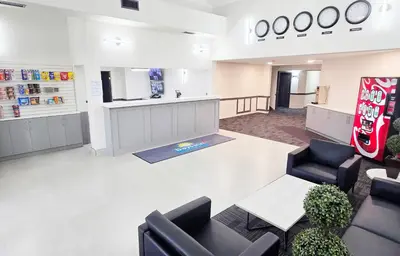 an empty waiting room with a soda machine and chairs at Days Inn by Wyndham Valemount in Valemount