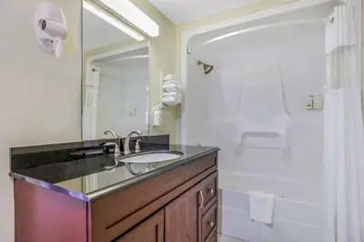 a bathroom with a sink and a shower and a mirror at Days Inn by Wyndham Golden in Golden