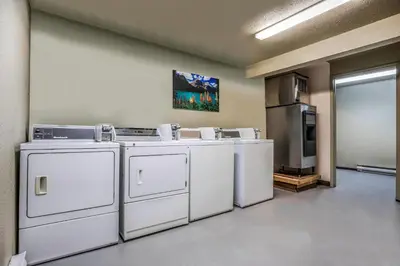 a laundry room with white washers and a refrigerator at Days Inn by Wyndham Golden in Golden