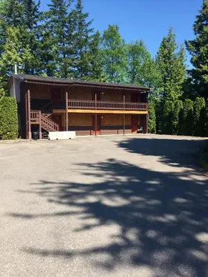 a large building with a large driveway in front of it at Copper River Motel in Terrace