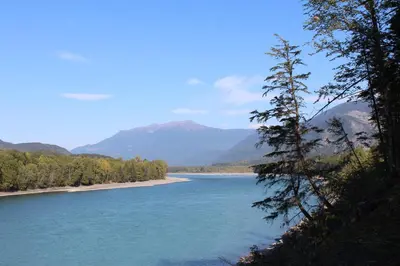 a view of a river with mountains in the background at Copper River Motel in Terrace