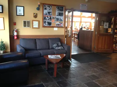 a living room with a couch and a table at Howe Sound Inn & Brewing Company in Squamish
