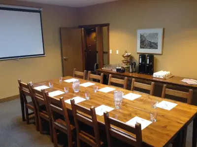 a conference room with a large wooden table and chairs at Howe Sound Inn & Brewing Company in Squamish