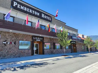 a building with american flags in front of it at Pemberton Hotel (Motel) in Pemberton