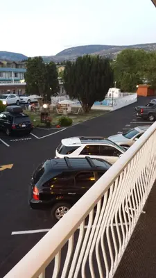 a black car is parked in a parking lot at Swiss Sunset Inn in Penticton